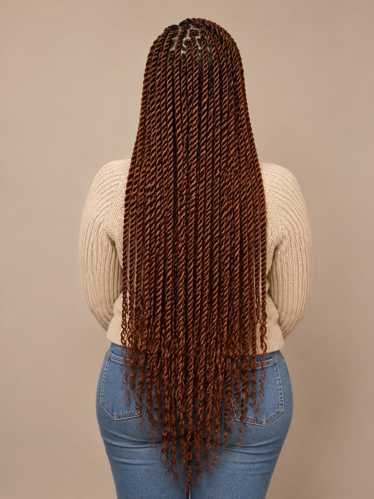Long copper-brown Senegalese rope twists viewed from behind, styled at Dixa Hair & Beauty Salon